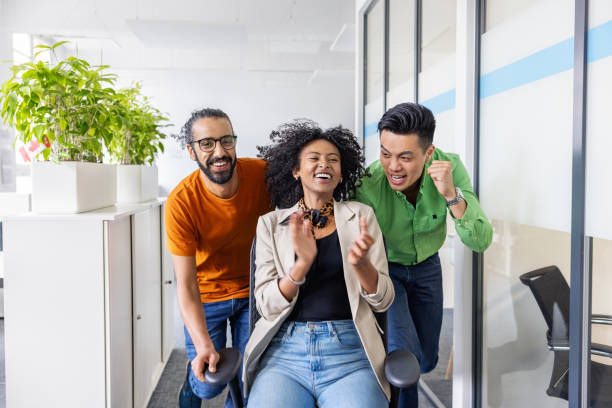 istock Business people cheering and having fun in office 1919289273