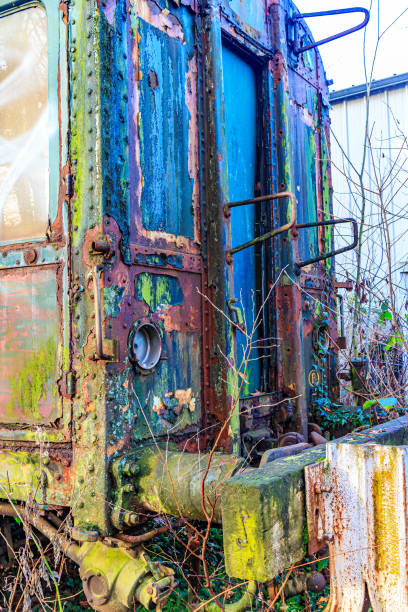 istock Side perspective of dilapidated, rusty, damaged and abandoned train carriages 1919292691