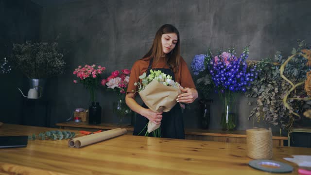 Florist woman crafts beautiful bouquets infusing joy with each flowers delicious scent front view. Florist's skill shines as she arranges vibrant blooms each bouquet masterpiece by florist.