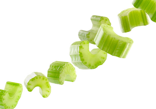 istock Pieces of celery fly in space forming a chain shape. Isolated on white 1919306810
