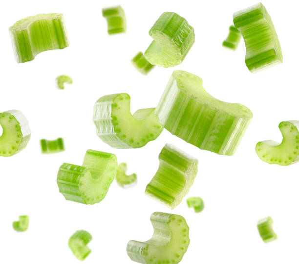 istock Pieces of celery fly and levitate in space. Isolated on white 1919307330