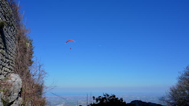 paragliding flight in a blue sky.