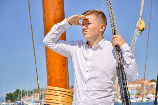 Young businessman and a marine posing in the city harbor