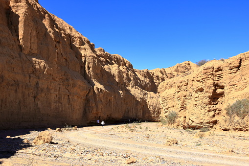 August 27 2023 - Aksai, Aksay in Kyrgyzstan: people enjoy the canyon formation at the Issyk Kul Lake