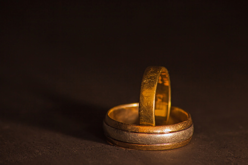 The well-worn wedding bands of a couple celebrating many decades of marraige