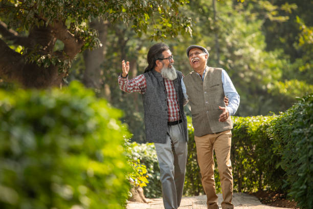 istock Senior friends talking and laughing in garden 1919366527