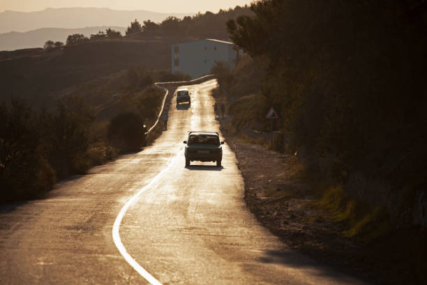 istock Car drives along the road at sunset. 1919381283