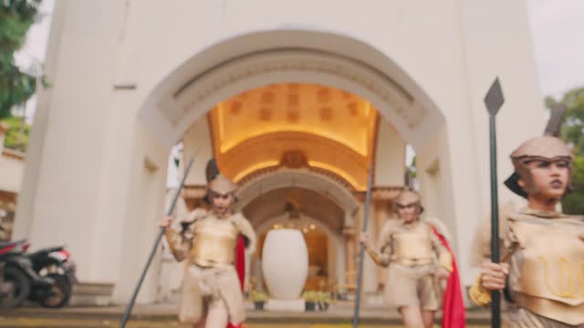 A group of soldiers in golden armor walked together down the steps of the royal colosseum to battle the enemy