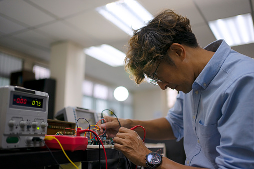 Engineer work with electronic component at workshop. Invention and technology.