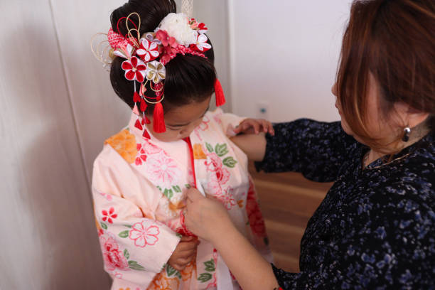 istock Asian mother put in her daughter's kimono 1919440128