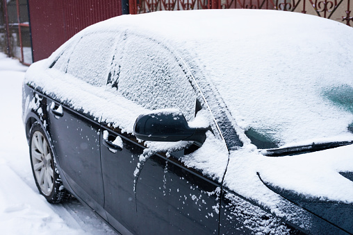 A light dusting of overnight snow on a parked truck in a residential neighbourhood in Surrey, British Columbia. Winter morning in Metro Vancouver.