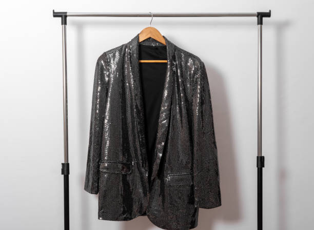 istock Shiny jacket hangs on hanger against white wall. Rental  clothing concept. 1919447057