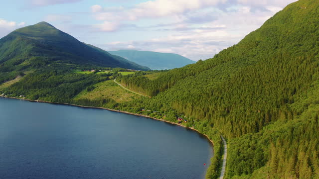 Aerial Scenic Summer Scandinavian Landscape with Road by Lake in Mountains During Sunset