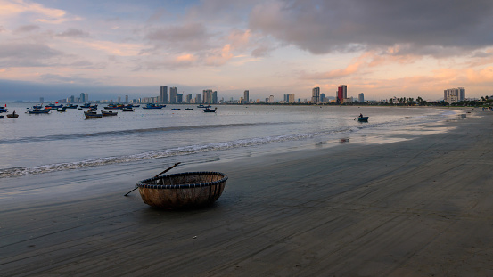 Fishing boats at My Khe beach with sunrise in Danang , Vietnam, Bamboo basket boat, Local fishing boats in Vietnam