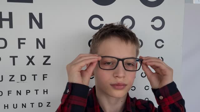 Boy with glasses in the ophthalmologist office