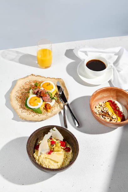 istock A complete breakfast set with sunny side up eggs, oatmeal, and yogurt with coffee and orange juice on a bright table 1919496971