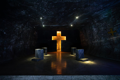 Illuminated cross representing stations of the cross, illustrate the events of Jesus last journey glows with spiritual light in the underground Catedral de Sal (Salt Cathedral) of Zipaquira, Colombia.