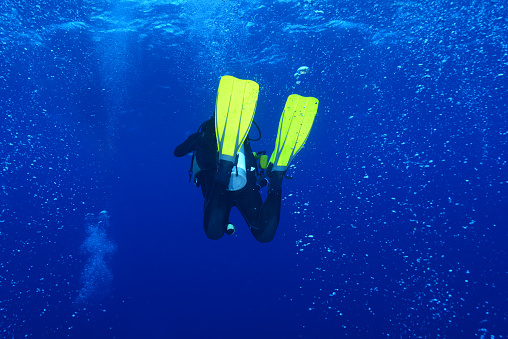 Water sports. Pretty scuba diver, attractive women, Happy after scuba diving.  Sporting women. Beautiful blue sea in the background.