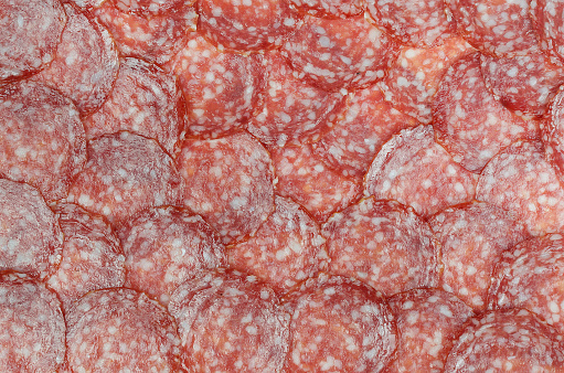 Texture of fresh sausage salami. Top view, copy space.