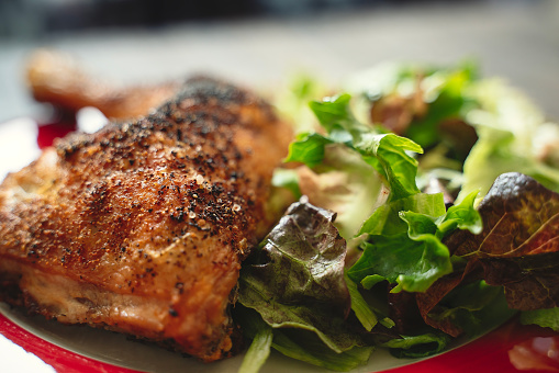 Roasted chicken and salad close-up