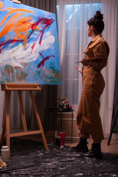 istock Artist admiring painting 1919543231