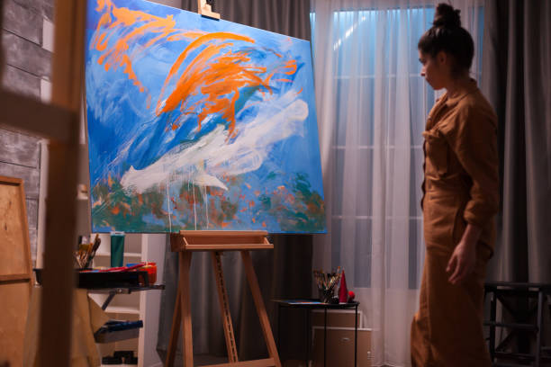 istock Artist checking painting 1919543756