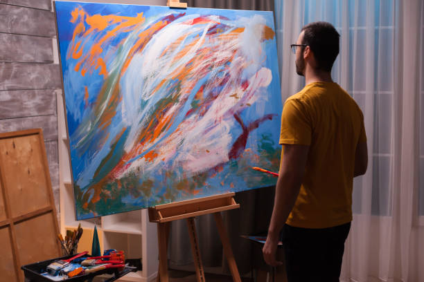 istock Artist in front of painting 1919545877