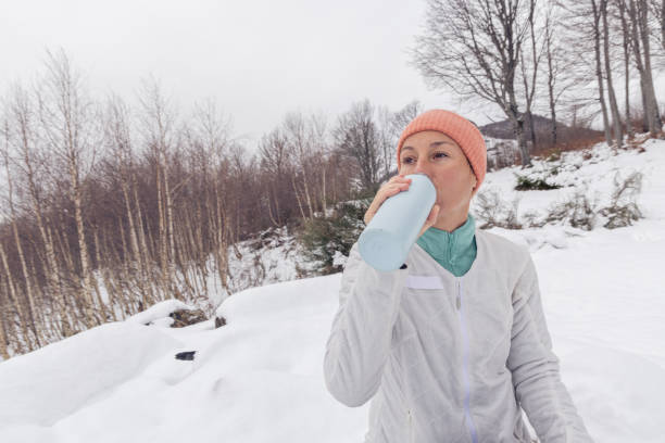 istock Woman on a hike takes a break, drinks from reusable bottle 1919553624