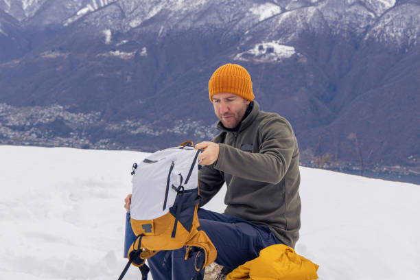 istock Male hiker taking a break, warming up with a hot drink 1919554373