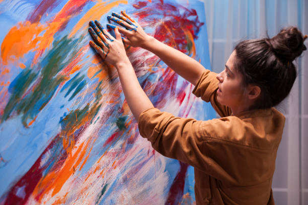 istock Creative artist painting with fingers 1919558091
