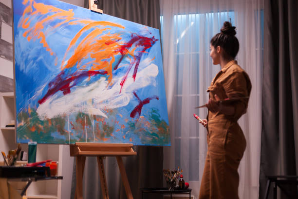 istock Happy artist in art studio 1919565434