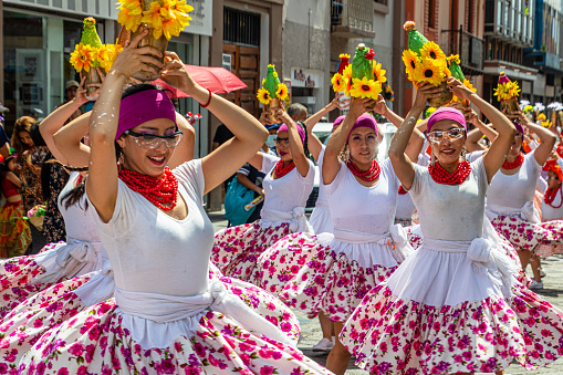 Cuenca, Ecuador - February 18, 2023: Parade during the Carnival in Cuenca. A group of dancers represents the Afro-Ecuadorian culture (Afro-Choteñas) of the mountains (from Chota Valley) with a bottle