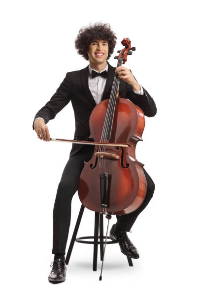 istock Young man sitting on a chair with a chello and a fiddle 1919635571