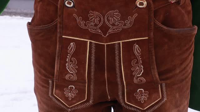 The lower part of the men's national costume, brown leather cropped trousers with embroidery in the national style