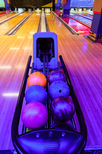 Racks with bowling balls. Bowling ball return system in bowling hall.