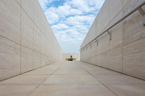 Lonely men in futuristic concrete urban environment.