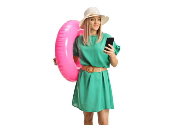istock Female tourist with a swimming ring browsing on a smartphone 1919652945