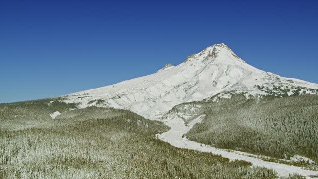 AERIAL Snow covered slope of Mt. Hood, Oregon on a sunny day