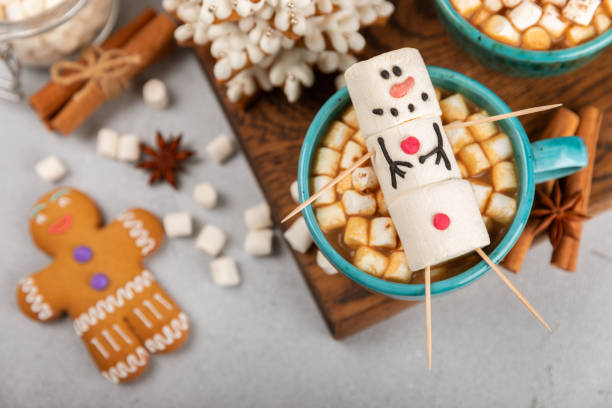 istock Hot drink with marshmallows and candy cane in cup on texture table.Cozy seasonal holidays.Hot cocoa with gingerbread Christmas cookies.Hot chocolate with marshmallow and spices.Copy space. 1919661255