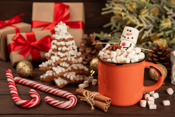istock Hot drink with marshmallows and candy cane in cup on texture table.Cozy seasonal holidays.Hot cocoa with gingerbread Christmas cookies.Hot chocolate with marshmallow and spices.Copy space. 1919661266