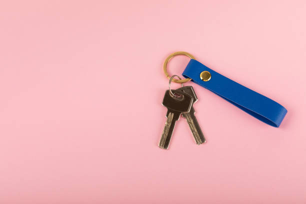 istock Keychain with key ring on a colored background. Concepts for real estate and moving home or renting property. Buying a property. Mock-up keychain.Copy space. 1919662320