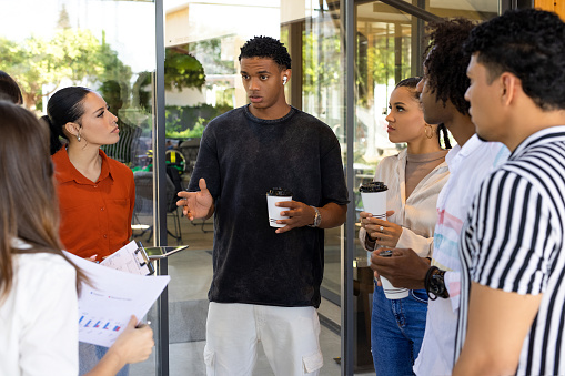 Colleagues standing in a small group discussing something