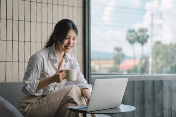 istock Female Business Professionals Working on Laptops and Enjoying Coffee at Cafes. Remote work concept 1919717114