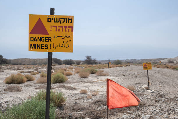 istock Minefields Sign with the text: Warning! Danger Mines in three languages on the south borders in Israel. 1919719268
