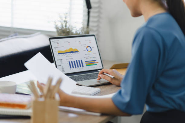 istock Analyst woman working with information database to analyze marketing and sales data. Business analytics dashboard with charts, metrics, and KPIs concept. 1919725246