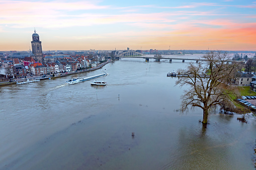 Aerial from a flooded river IJssel near Deventer in the Netherlands at sunset