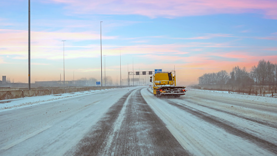 Snowy highway A1 near Amsterdam in the Netherlands at sunset