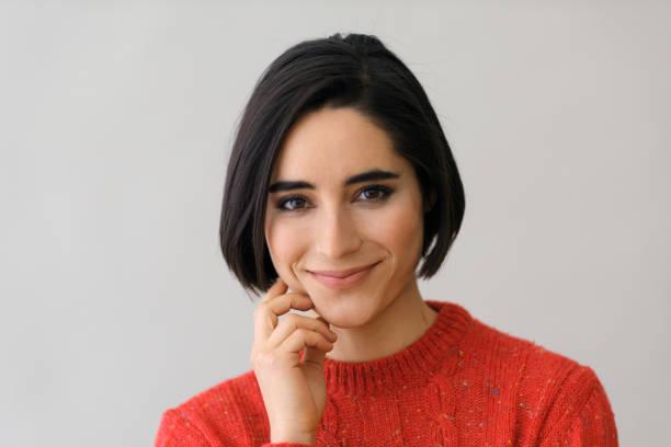 istock Smiling woman thinking with hand on chin 1919748724