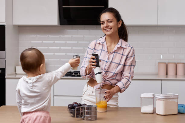 istock mother with her little daughter cooking at kitchen. 1919751406