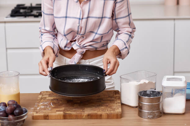 istock baker woman preparing pie in modern kitchen 1919751417